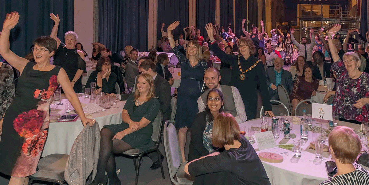 Guests at the 2016 dyslexia awards, wavign at the camera to show they are dsylexic and proud!
